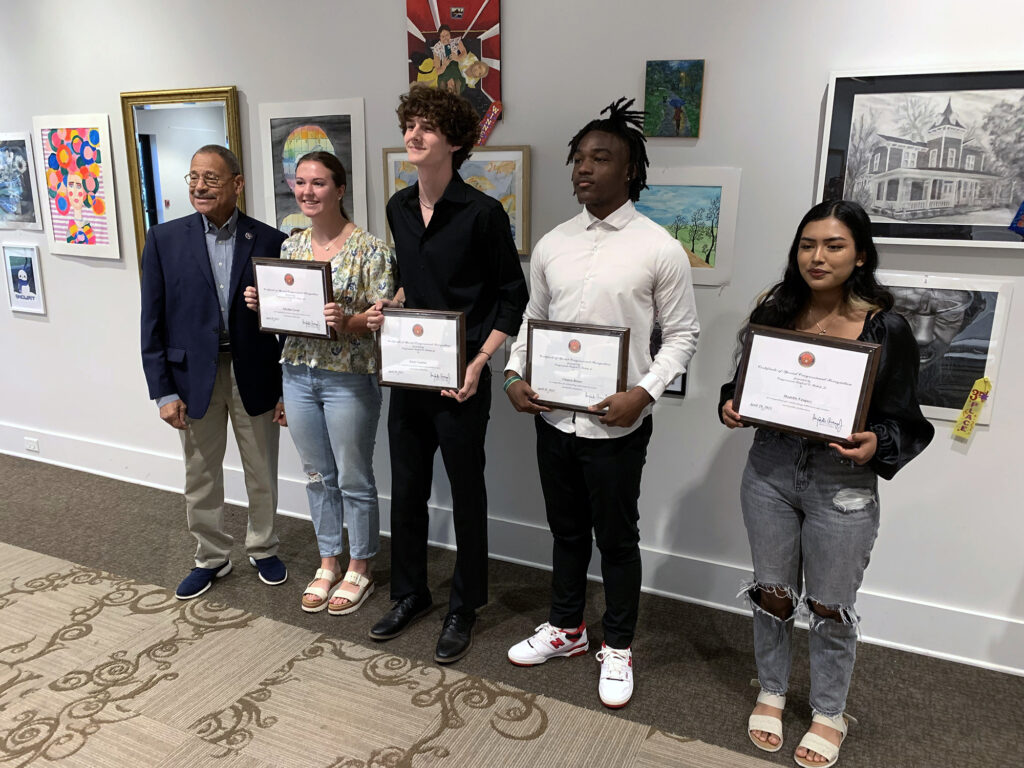 Congressman Sanford Bishop poses with four high school students who were winners in the 2023 Congressional Art Competition for the Second Congressional District of Georgia