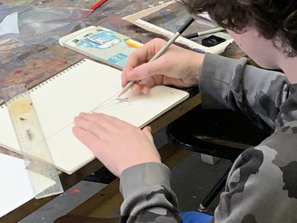 Student works on drawing in Albany Museum of Art classroom