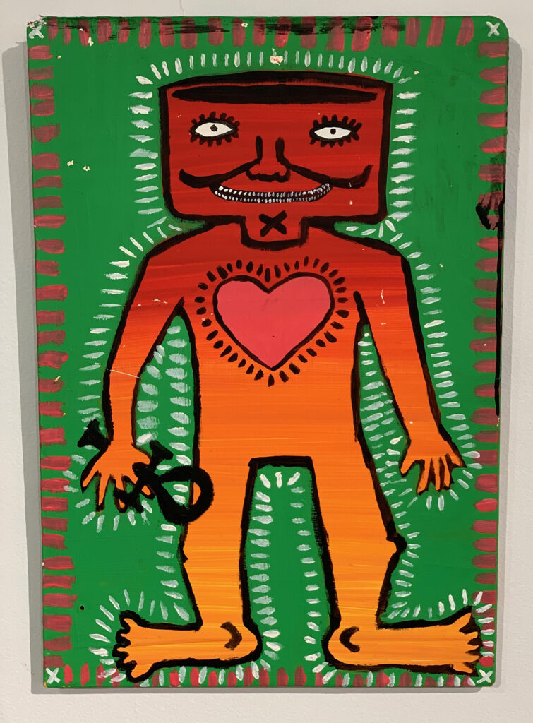 Orange male figure holds an ankh and has heart on his chest and white rays radiating from his body