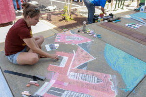 Anna Wilschetz creates image of church with chalk on sidewalk