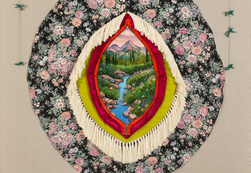 Flowing mountain stream with lush banks can be seen through an unzipped aperture with fringe and a floral border