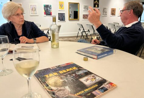man and woman discuss book at book club meeting