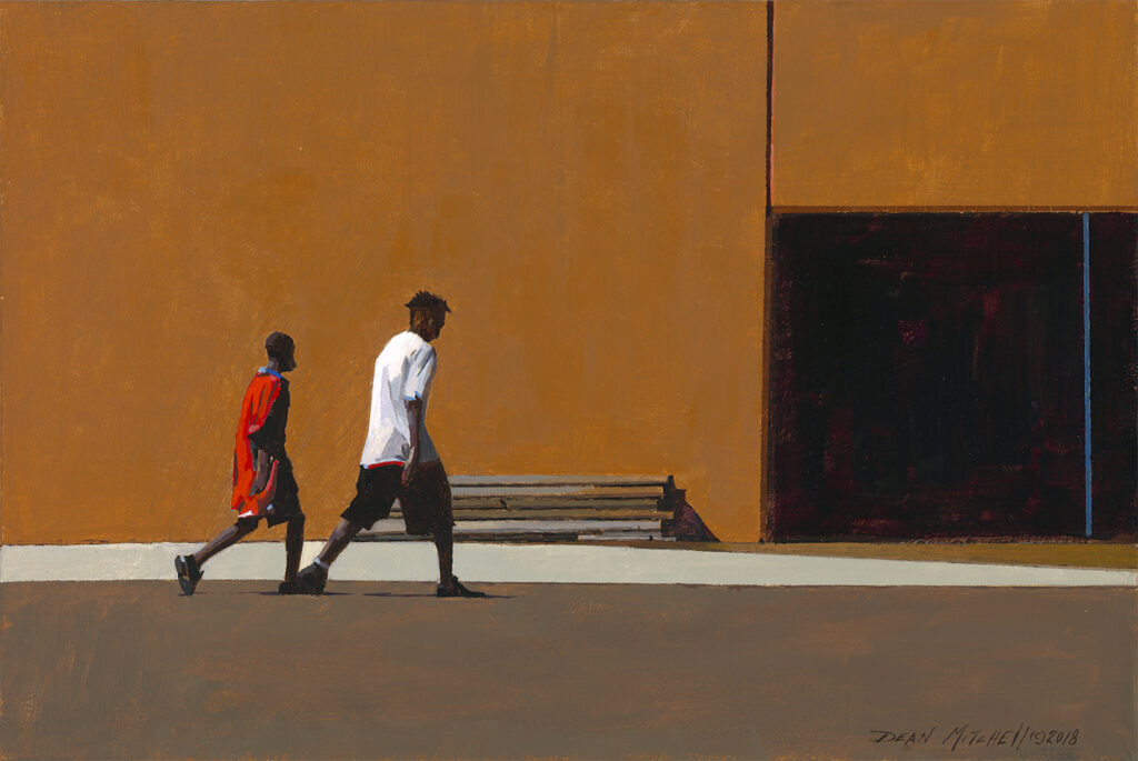 Two African-American youth walk on a empty urban street