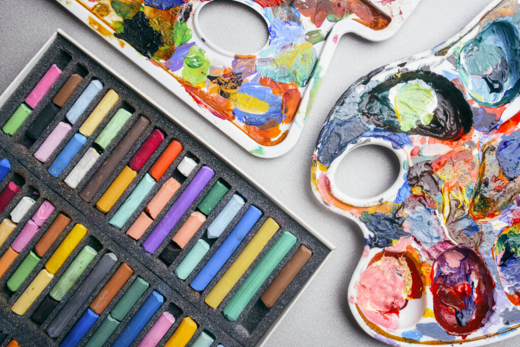 Image of paint palettes and pastel sticks