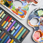 Image of paint palettes and pastel sticks