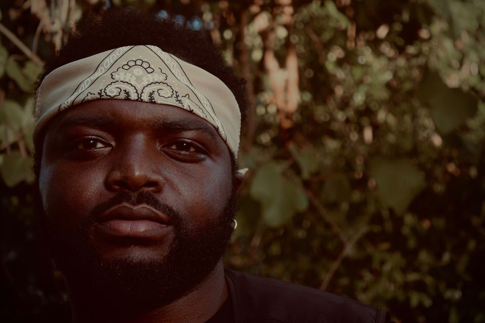 Man with headband looking forward with blurred background