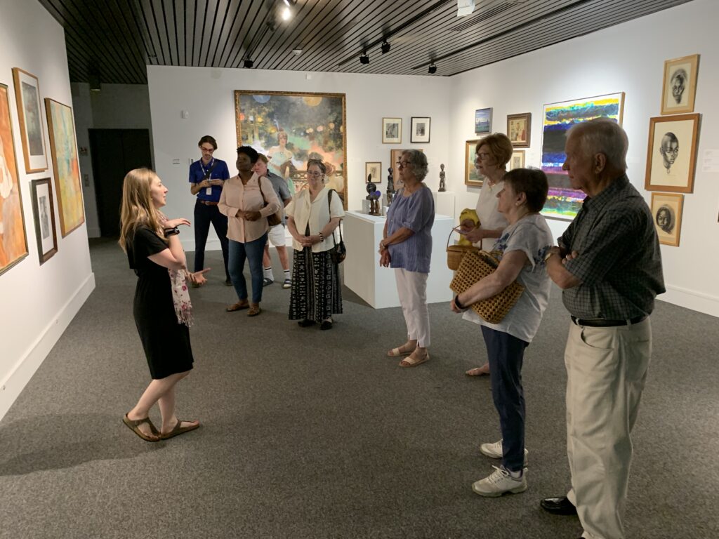 Curator leads group on tour od AMA gallery
