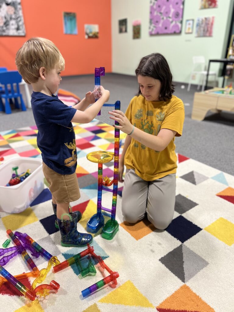 Two children play with building blocks in the activity room at the Albany Museum of Art