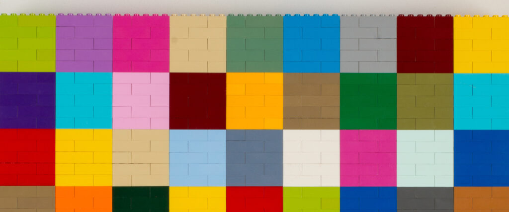 Multicolored Lego bricks are connected to make a geometric artwork