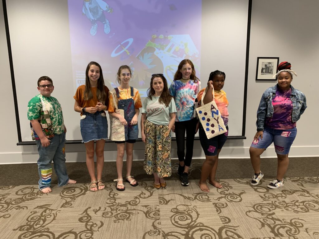 Fashion campers pose in their designs with teacher heather Ashberry at the 2021 Fashion Forward Camp