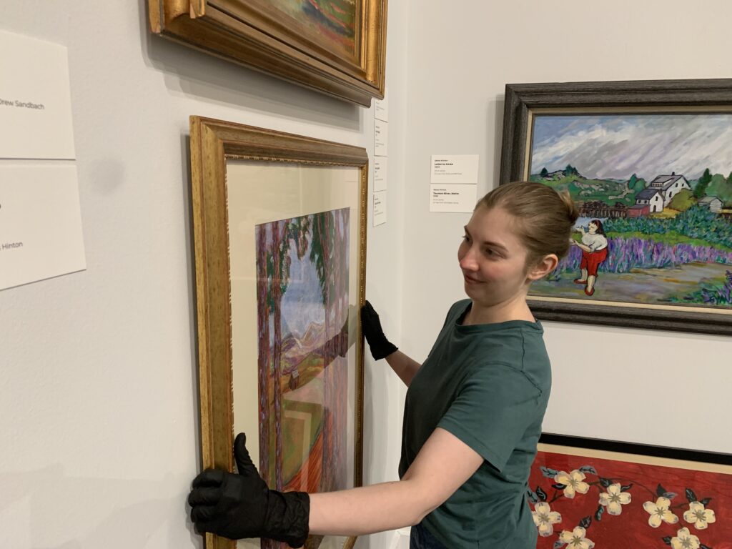 Albany Museum of Art Curator Katie Dllard hangs an artwork in the Haley Gallery.