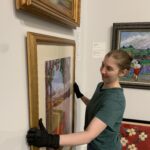 Albany Museum of Art Curator Katie Dllard hangs an artwork in the Haley Gallery.