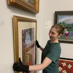 Albany Museum of Art Curator Katie Dllard hangs an artwork in the Haley Gallery.