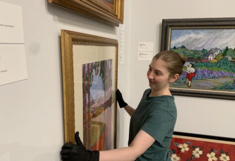 Albany Museum of Art Curator Katie Dllard hangs an artwork in the Haley Gallery.