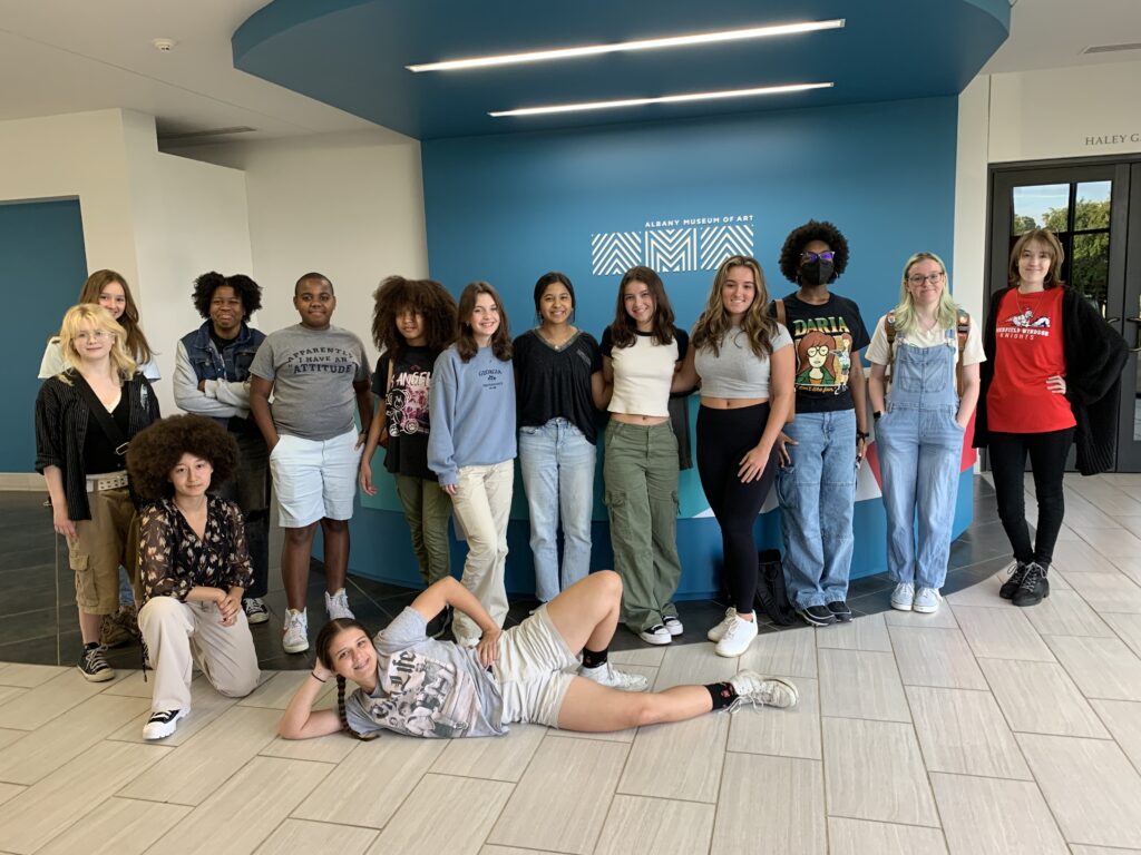 Members of the Teen Art Board are shown in the AMA lobby.