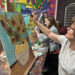 women paint sunflowers in van gogh style