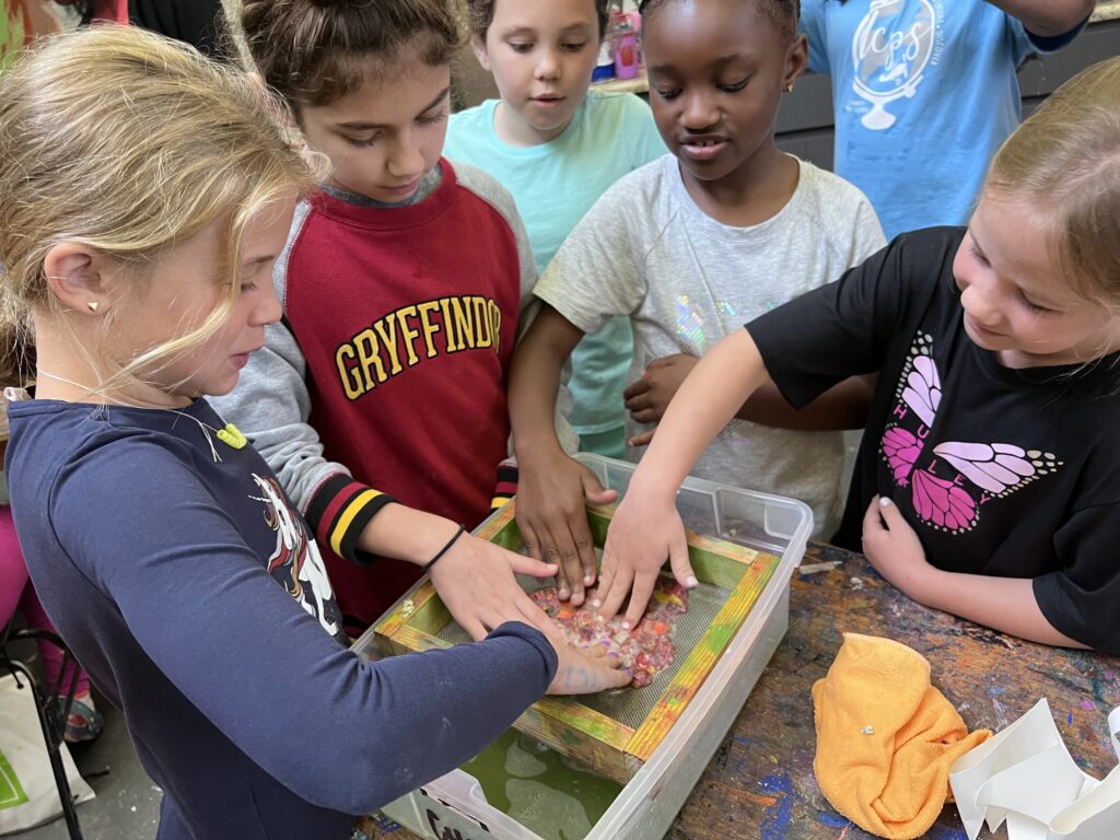 Campers engage in a hands-on art project in 2022 spring break art camp