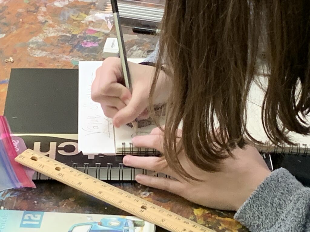 Student draws in AMA Classroom