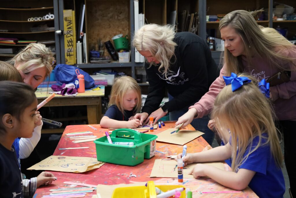 Students work on an art project during a visit to the AMA