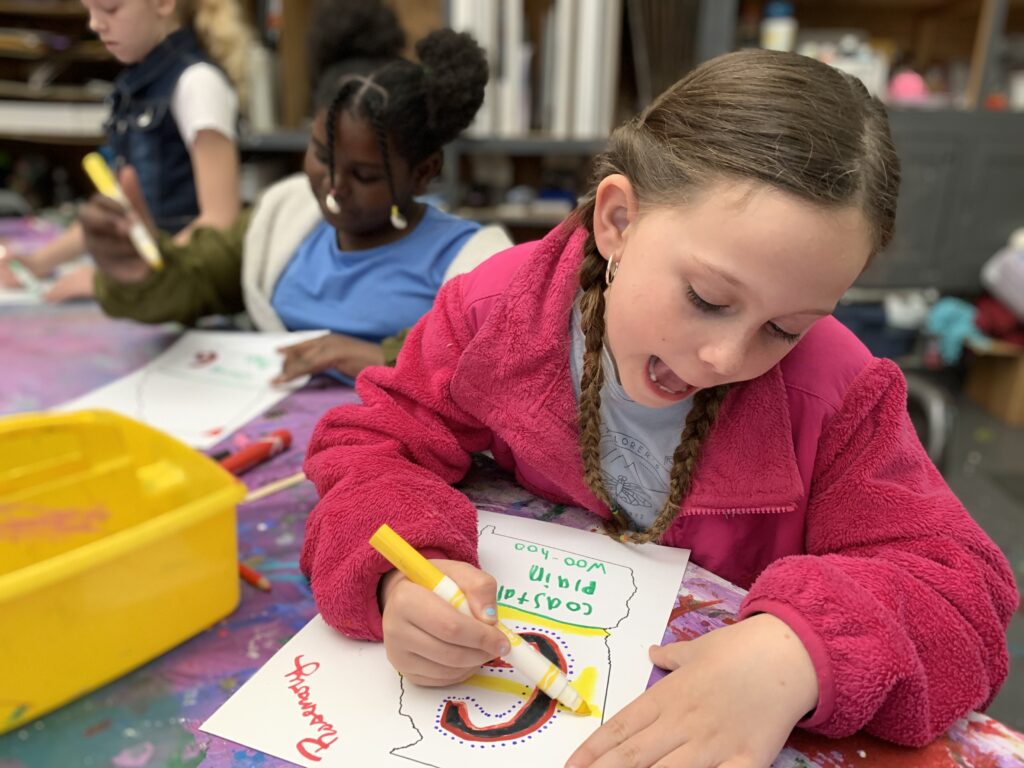 Elementary students work on an art project during a school tour at the AMA