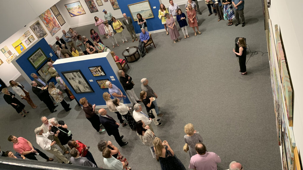 A large group of Albany Museum of Art members are seen from overhead in the Haley Gallery