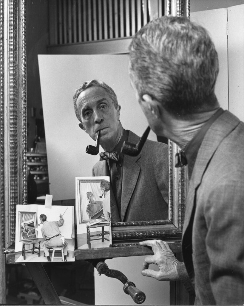 Norman Rockwell is pictured looking at his morrored reflection with small self portraits in front of him