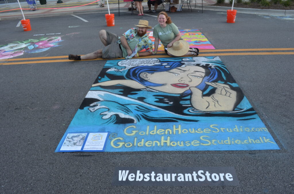 Couple pose with chalk art image of crying woman