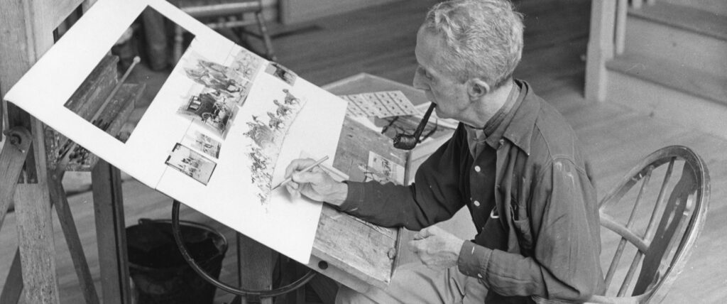 Norman Rockwell works on a drawing in his studio