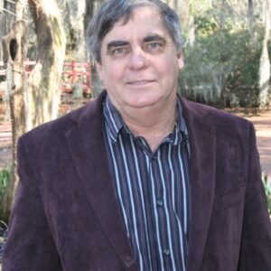 Tom Johnson is shown with trees in the background