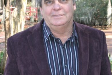Tom Johnson is shown with trees in the background