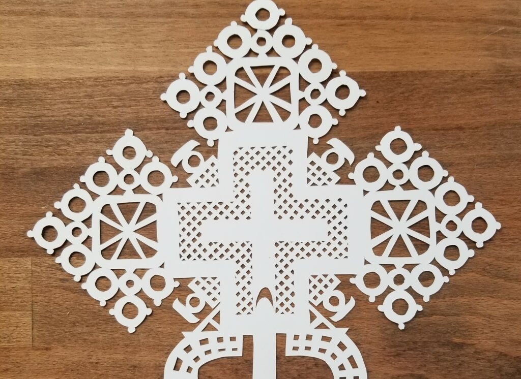 papercut cross with wood background