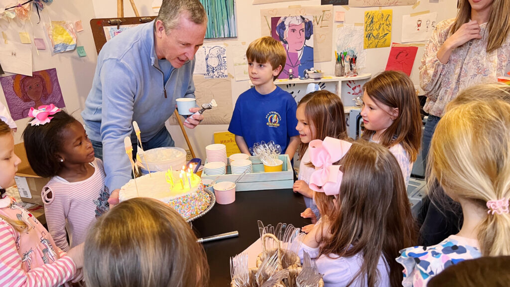 Children and dad enjoys treats at child's birthday party